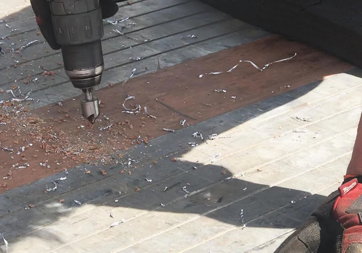 Countersinking a tapered bevel around a predrilled hole in a trailer deck board