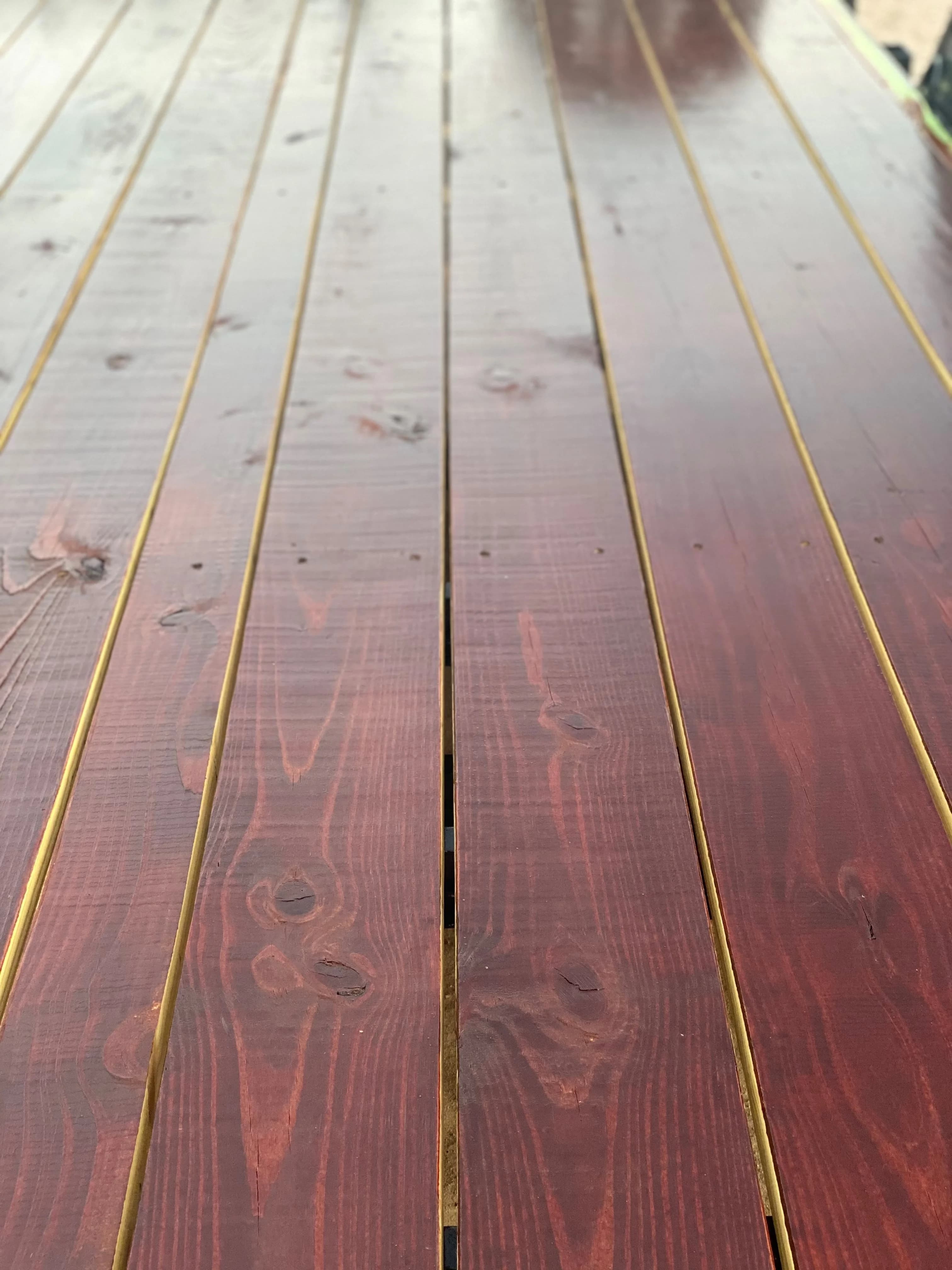 Apitong Oil applied to a softwood utility trailer deck — refreshed dark amber color