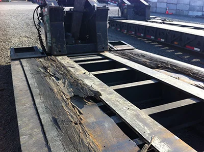 Weathered, unprotected hardwood boards on a lowboy trailer deck